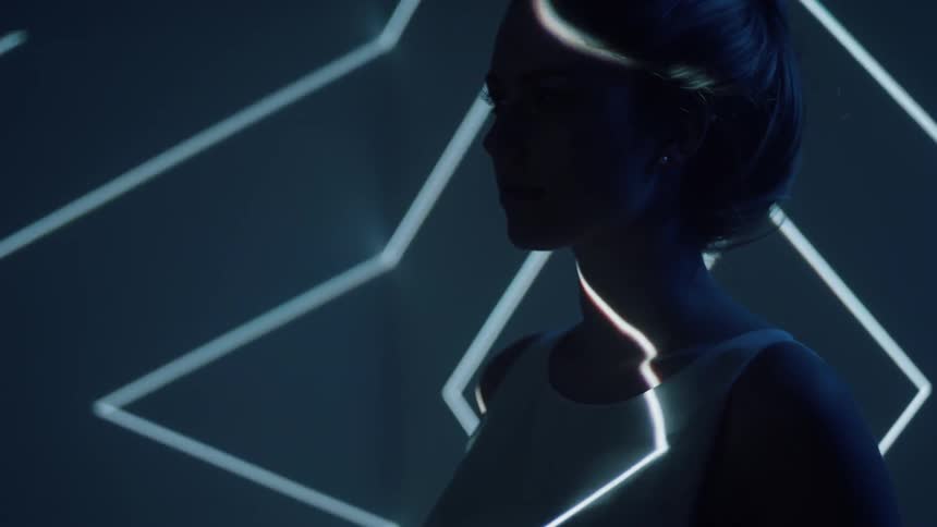 Woman looking to the side with lights shining off her