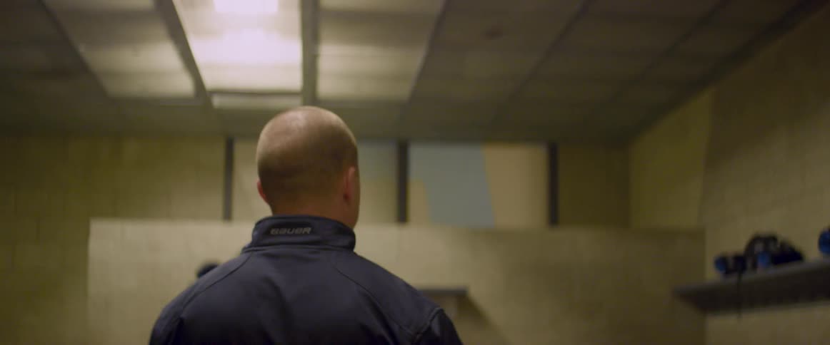 A coach walks into the dressing room