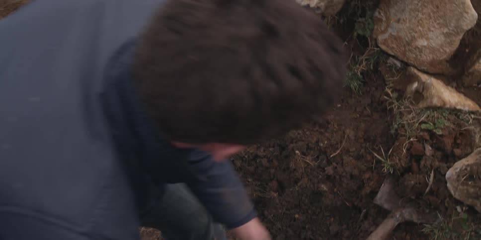 And man is burying something in the woods