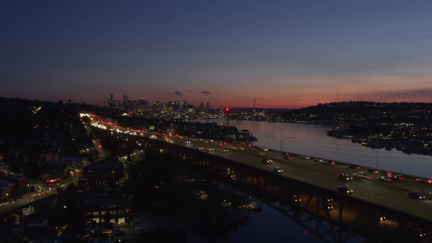 Vehicles driving on a city freeway at dusk
