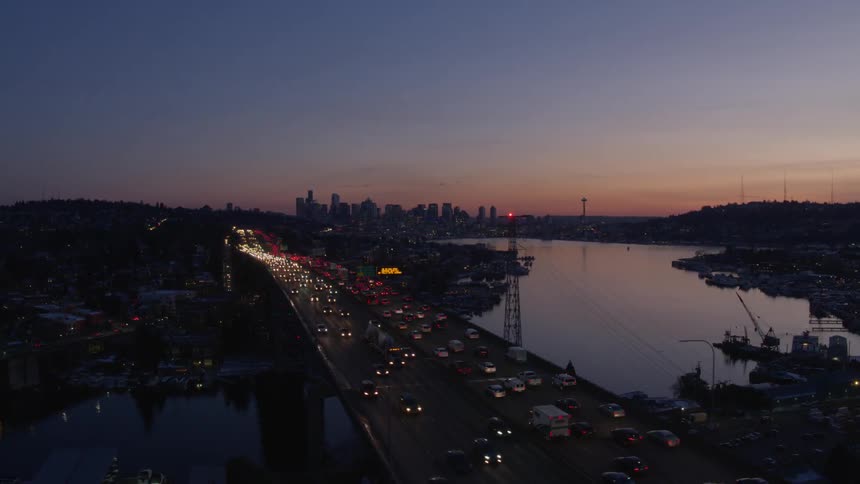 Orbit over heavy traffic on an urban freeway at dusk