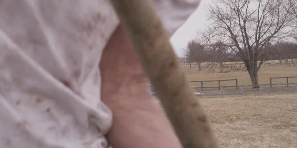 A boy is digging in the field