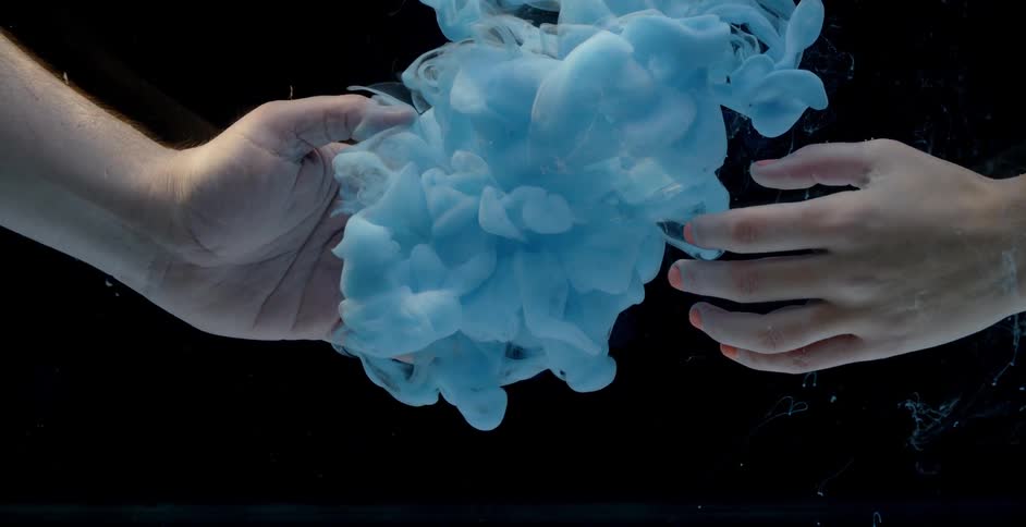 Two people reach out to the blue cloud in the water