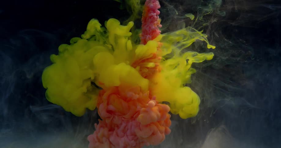 Billowing clouds of colored dye are spreading out in water