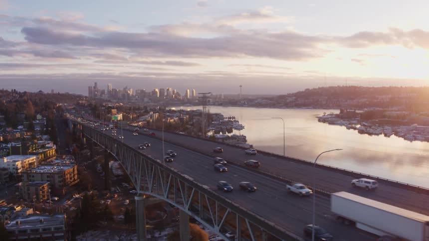 Descending over light traffic on the Ship Canal Bridge with Lake Union and downtown Seattle in the distance