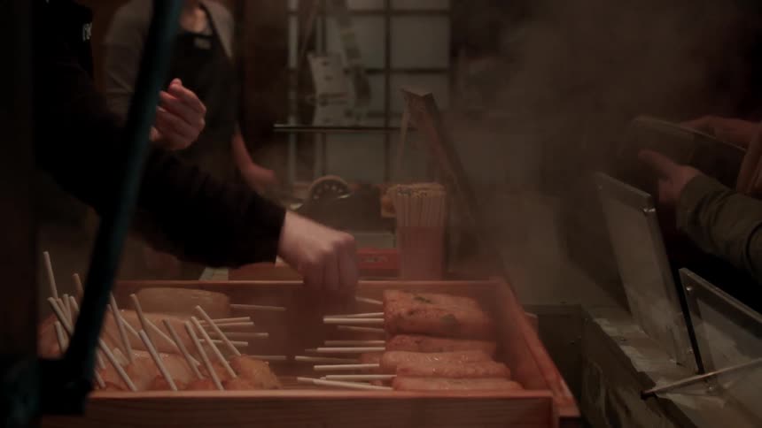 A restaurant is preparing food on sticks