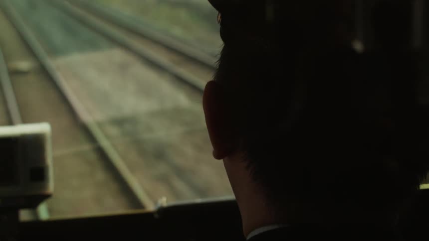 A conductor drives a train