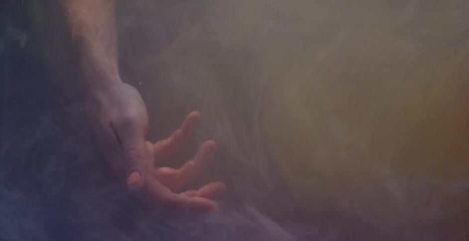 Woman's hand floats to the bottom of the lake