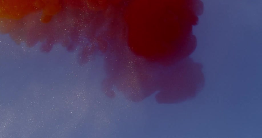 Clouds of dye float and expand down into liquid