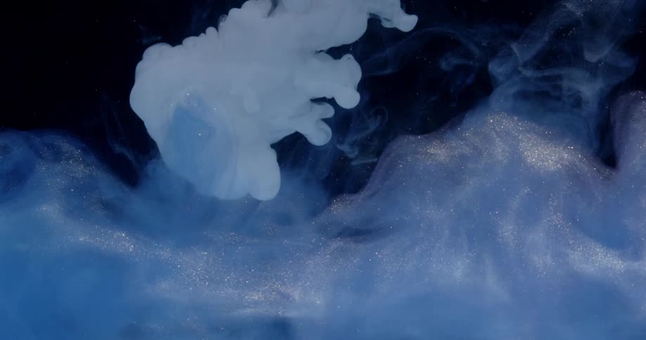 Glitter and dye swirl in water