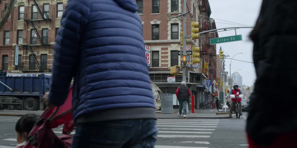 People travel on the city street on a cloudy day