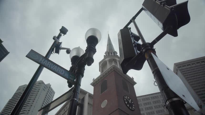 Streetlights stand next to a clock tower