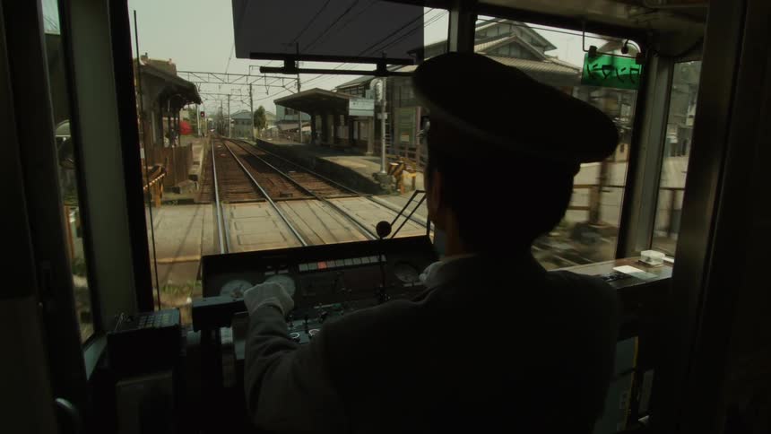 Conductor drives a train down the tracks