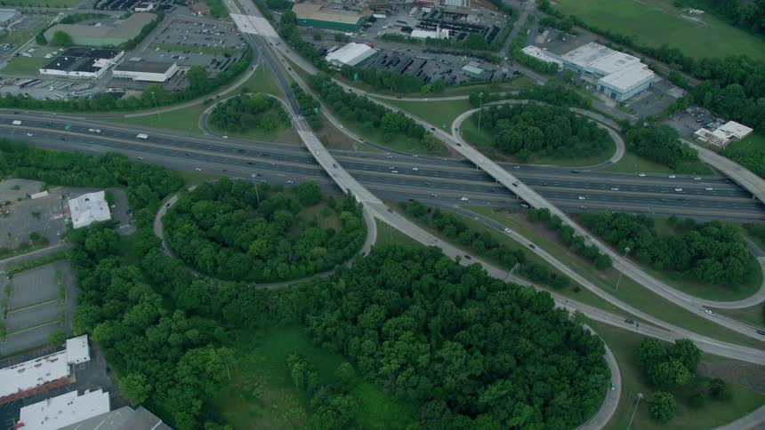 Cars travel over and under a highway interchange