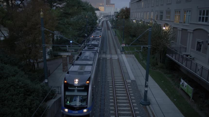 A train is moving over the tracks at dawn