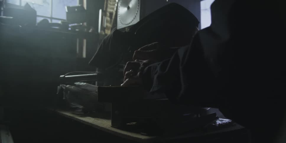 Person working on something in a dark room