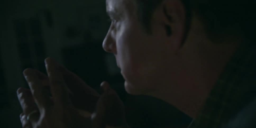 A man sits and thinks at night
