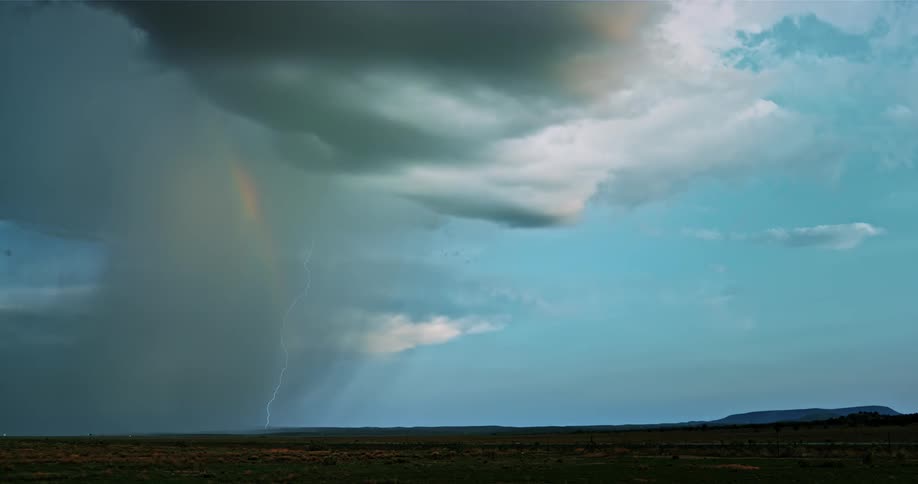 Lightning and rain pour from the storm clouds ahead