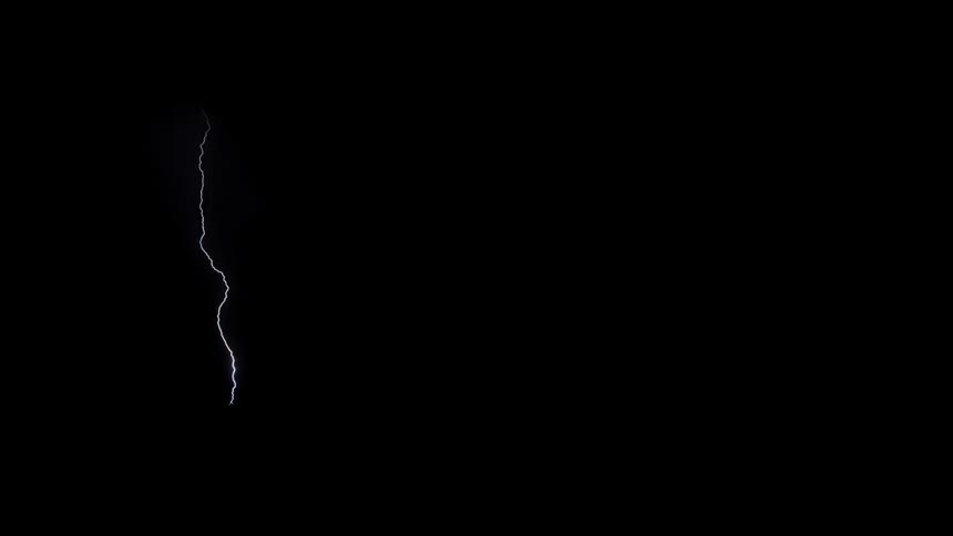 Lightning streaks across a dark sky near some power lines