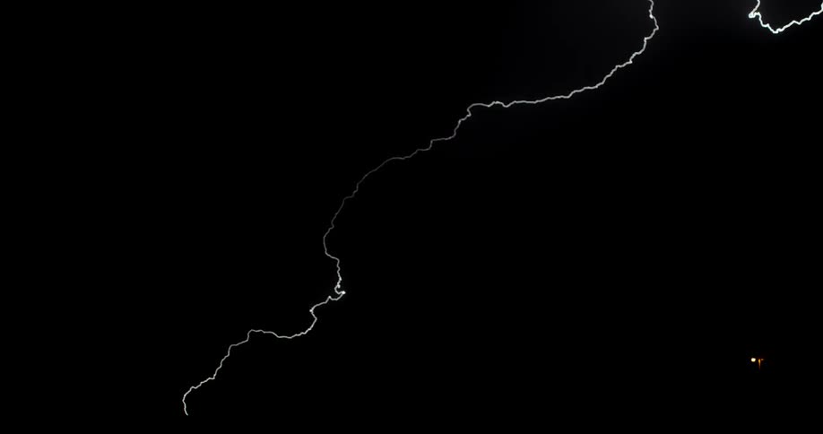 Lightning streaks across a dark sky