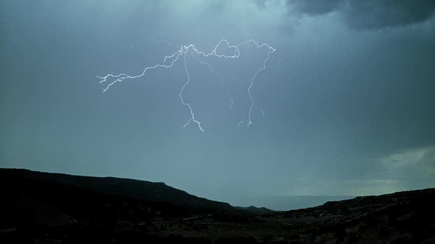 Streaks of lightning flash in the cloudy sky