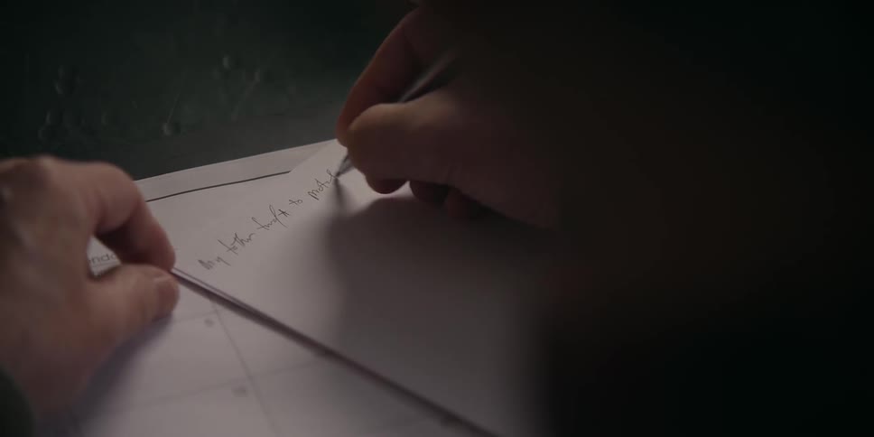 A person is writing a letter