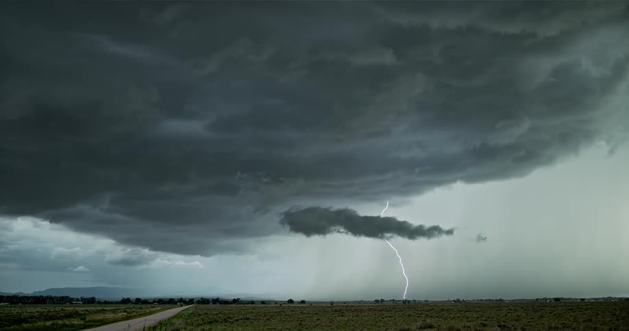 Heavy storm clouds move across the field shooting lightning