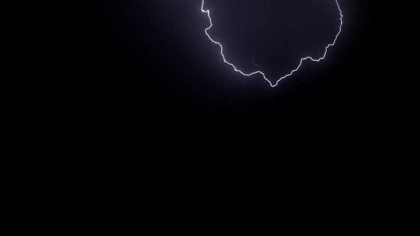 Lightning is flashing across the sky and striking the ground at night
