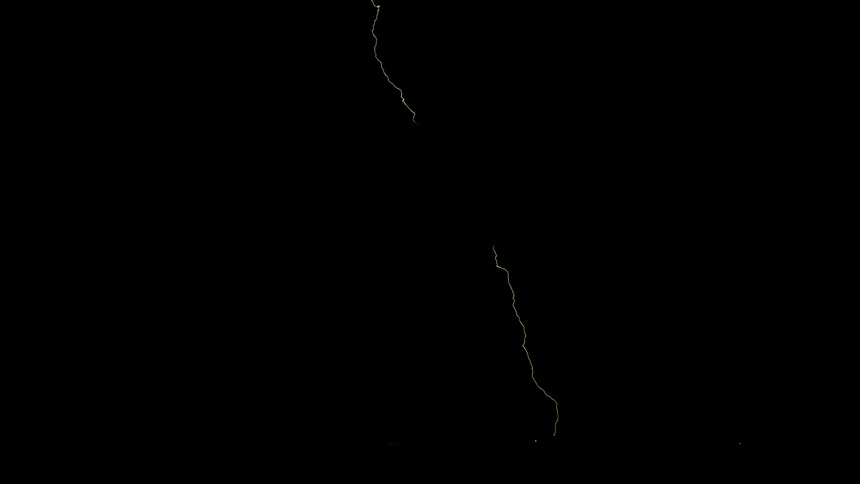 Streaks of lightning flash in the dark sky