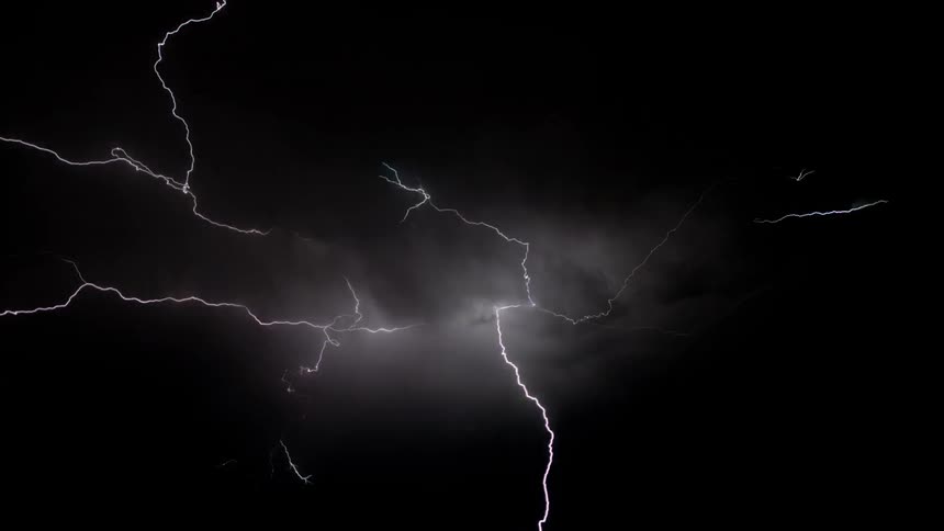 The lightning stretches in all directions of the night sky