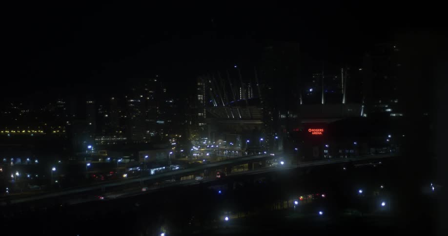 Traffic travels over a bridge in the city at night