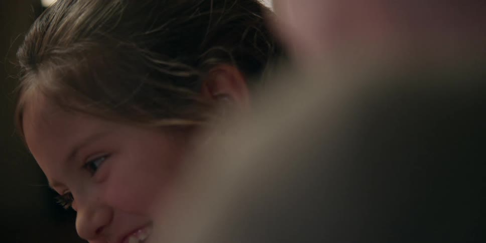 Girl smiles and nods before looking down