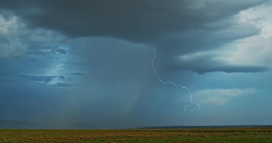 The rain is pouring behind the shooting lightning
