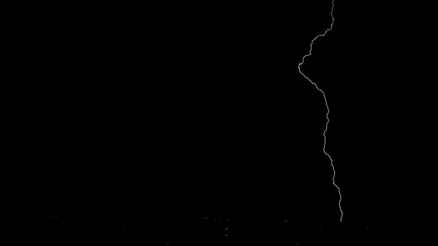 Lightning flashes in the dark sky