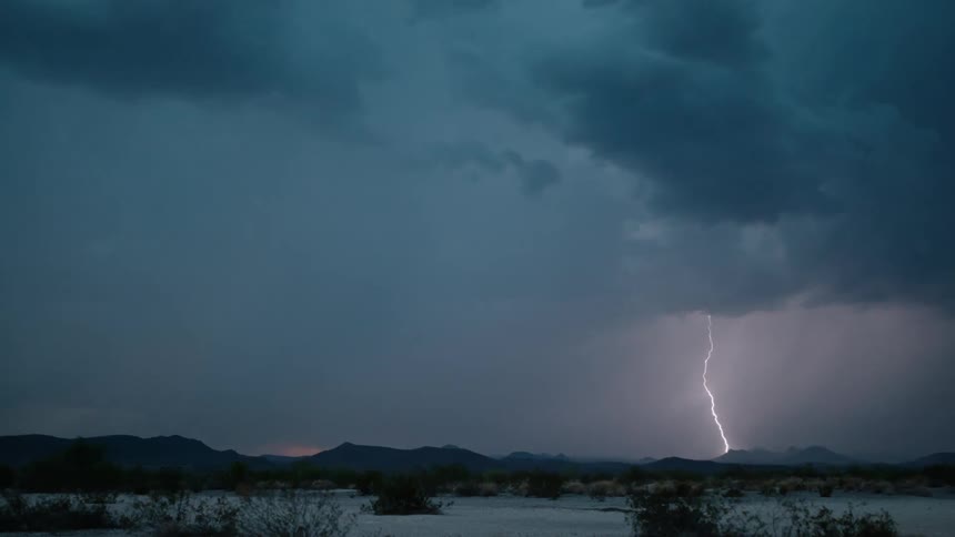 Storm clouds and lightning over a natural landscape
