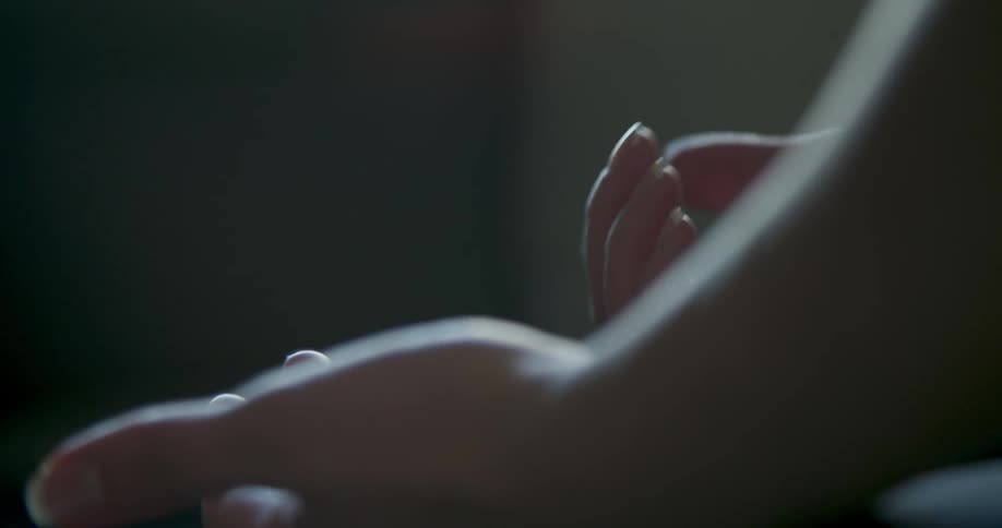 Hands sit clasped then spread out