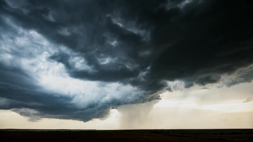 The rain pours from the storm clouds ahead