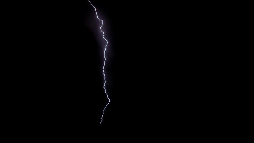 Lightning flashes and strikes the ground as a storm moves across a landscape at night