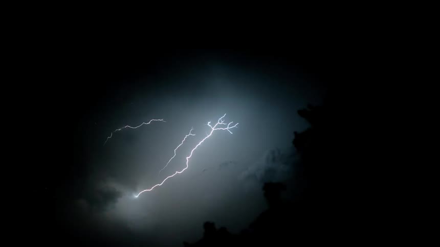 The black sky lights up with lightning