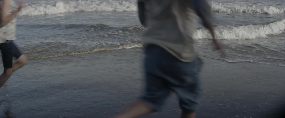 The children are running in the water by the shore