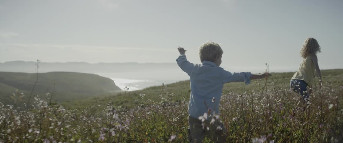 Children run through the flowers playing