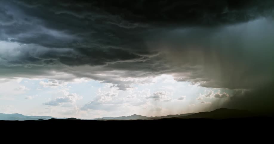 The large storm clouds pour rain and shoot lightning all over