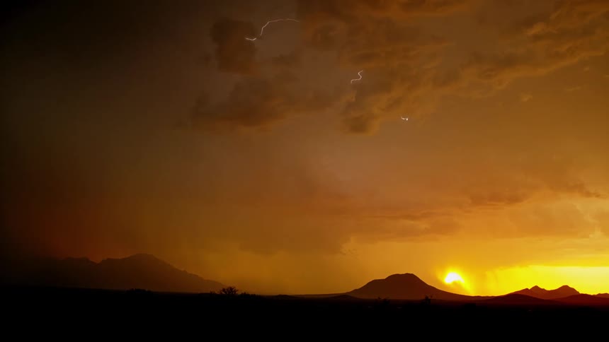 Lightning bolts and storm clouds at sunrise