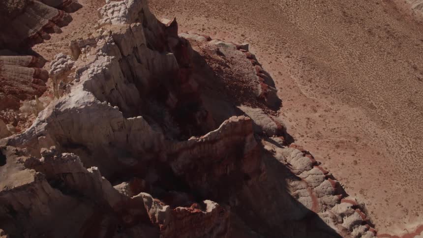 Rock formations rise above a desert landscape on a sunny day