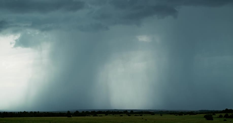 Lightning flashes brightly in the dark cloudy sky