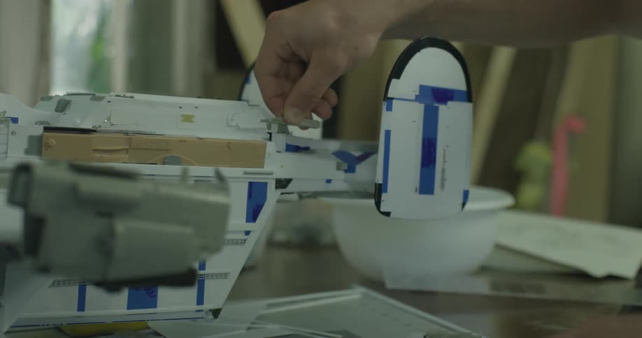 A person is slowly building a model aircraft