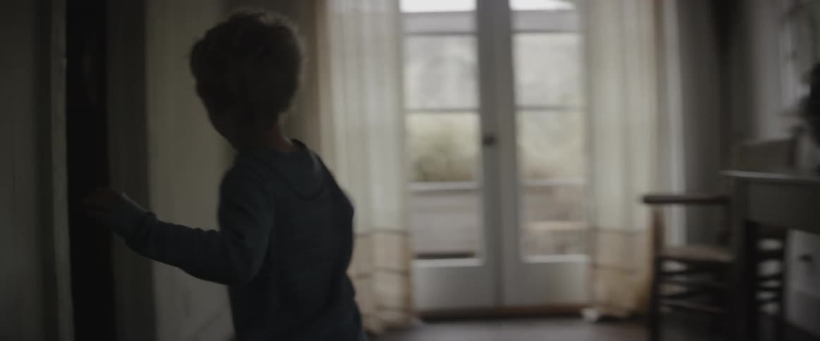 A boy is running and jumping into his parent's bed in the morning