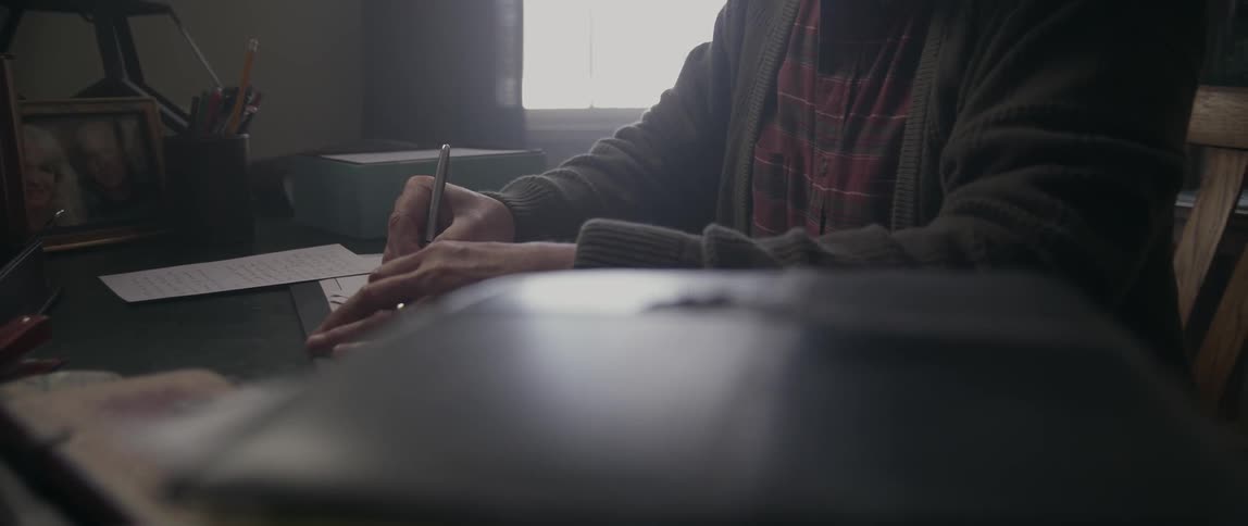 A man is writing a letter