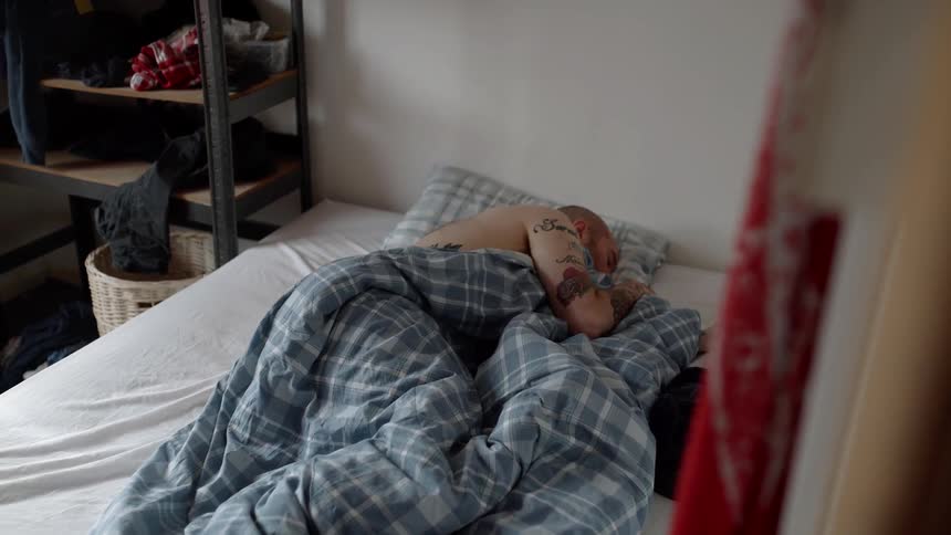 A man is sleeping in the bedroom