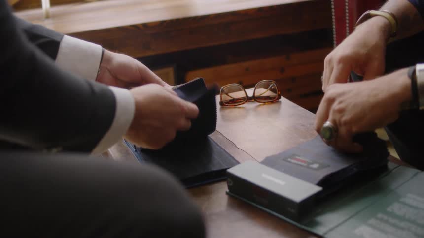 Two men look at fabric samples